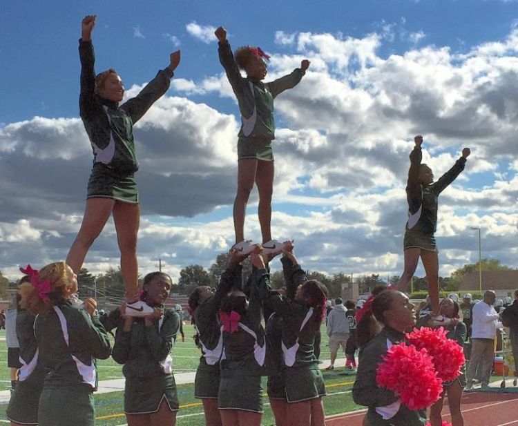 The Elmont Memorial High School cheerleaders perform at halftime during the school's 2015 Homecoming Day game on Oct. 17, 2015. (Photo by Heather Doyle, Newsday.)